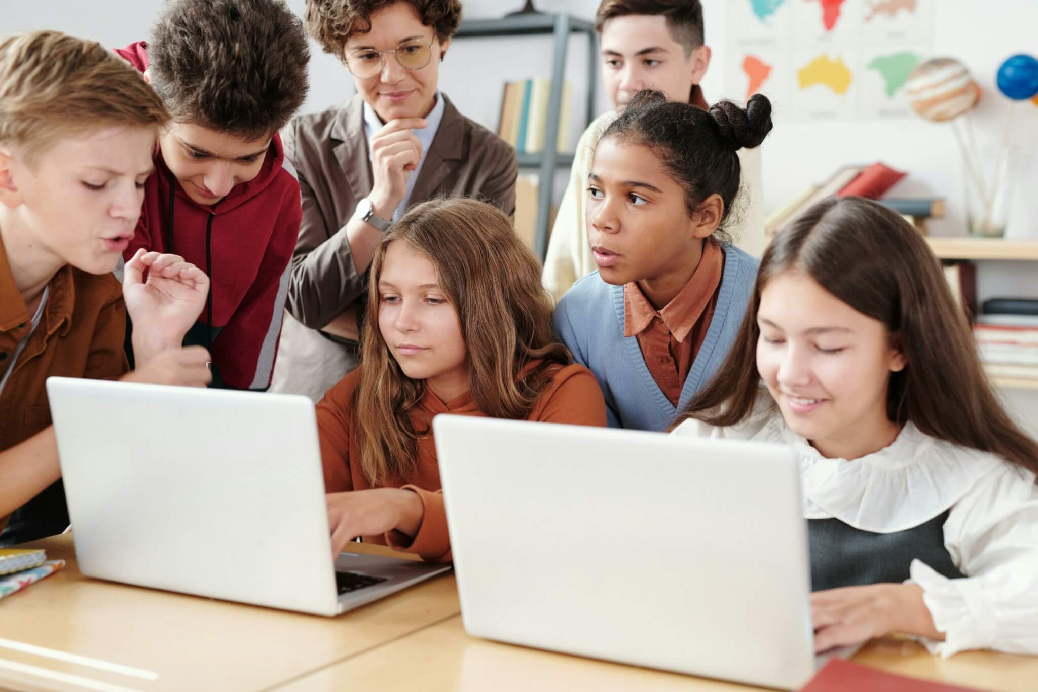 Image shows students collaborating on a school project